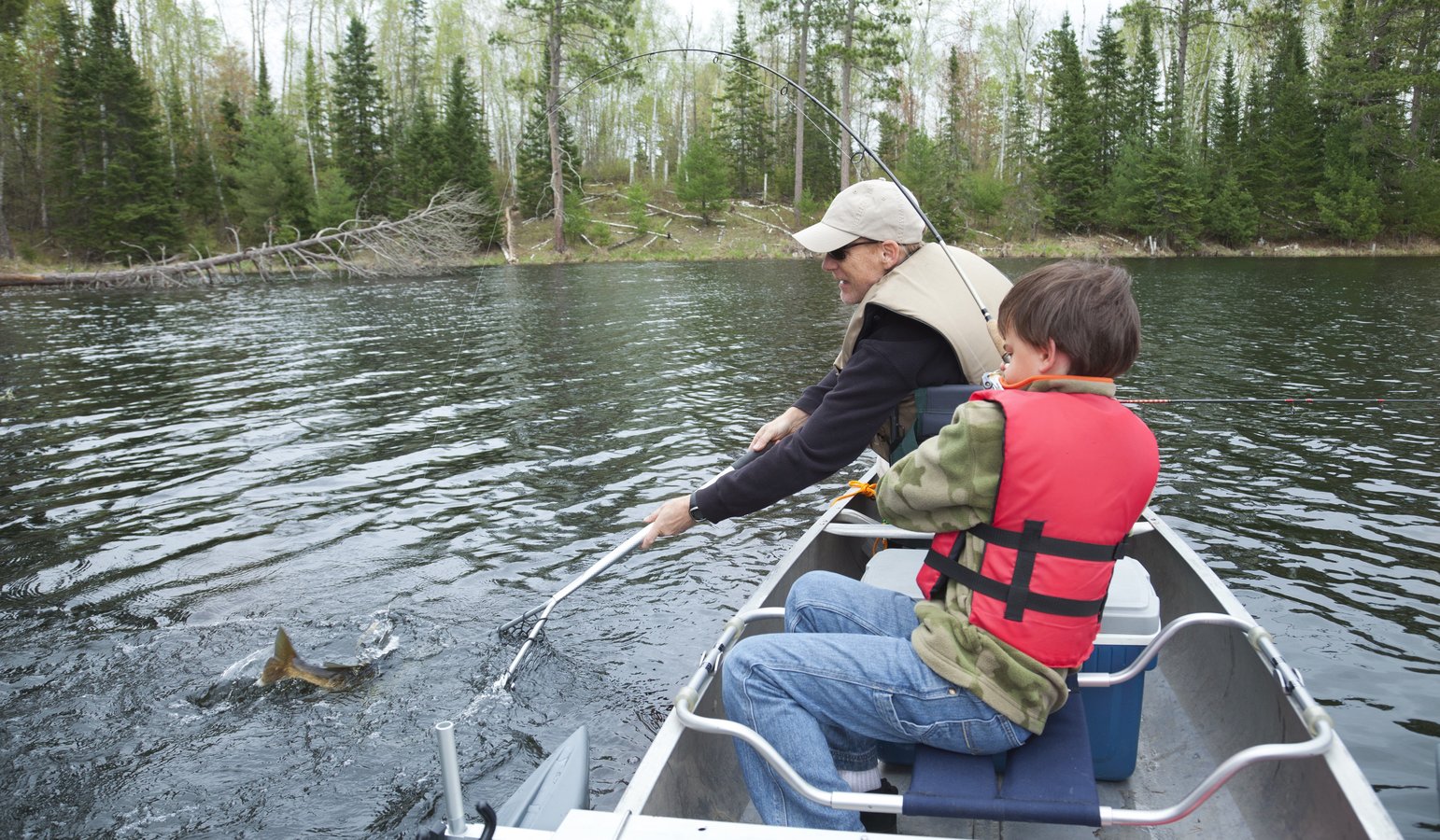 man fishing with boy